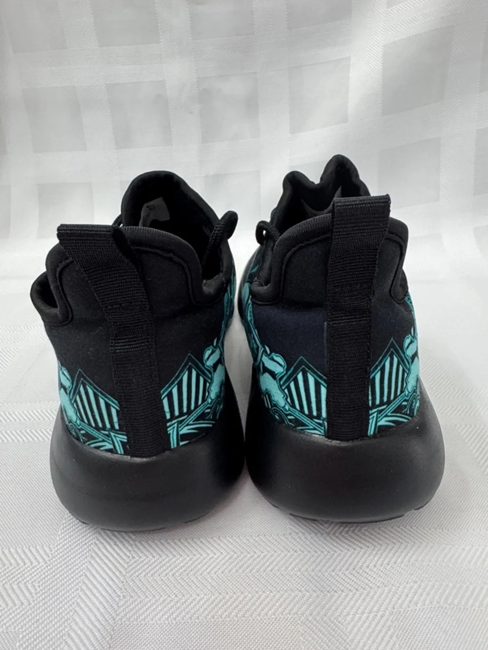 Unisex Black Lightweight Sneakers with Teal Skull Accent